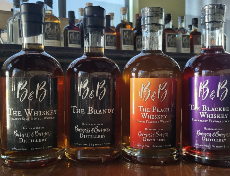 4 bottles of B & B Distillery spirit bottles on a bar